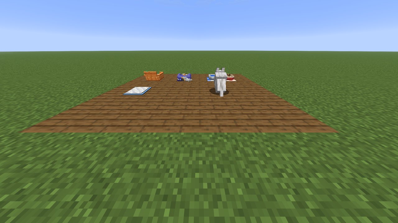 A finished pet corner: bowls, a bed, a litter box and a pee pad within a few blocks of each other.